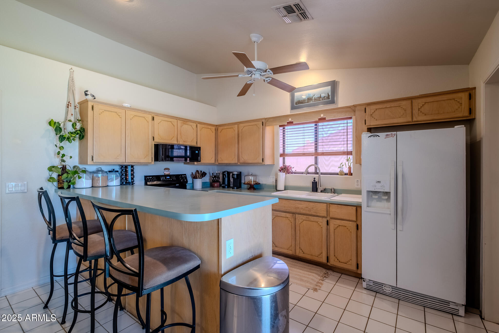 841 East Granada Avenue Apache Junction, AZ 85119 - Photo 16 of 33 a kitchen with stainless steel appliances a table and chairs in it