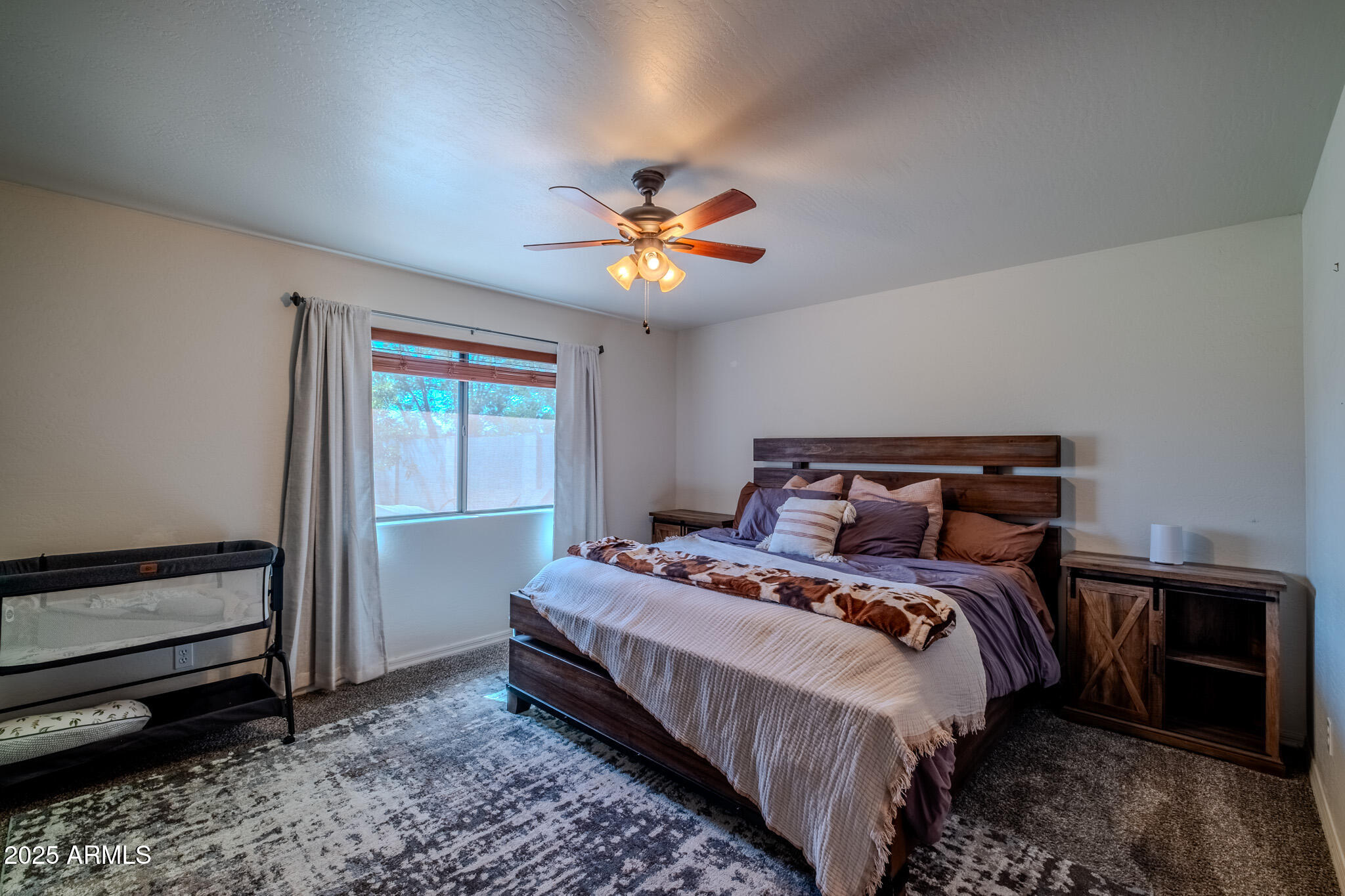 841 East Granada Avenue Apache Junction, AZ 85119 - Photo 18 of 33 a bedroom with a bed and a chandelier