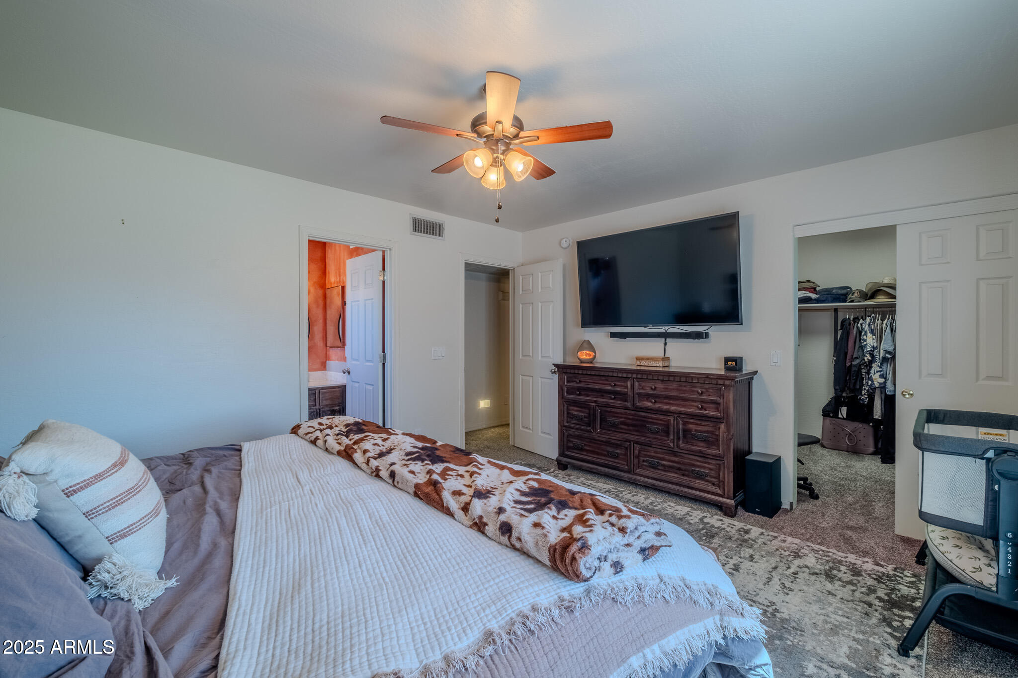 841 East Granada Avenue Apache Junction, AZ 85119 - Photo 21 of 33 a bedroom with a bed and a flat screen tv
