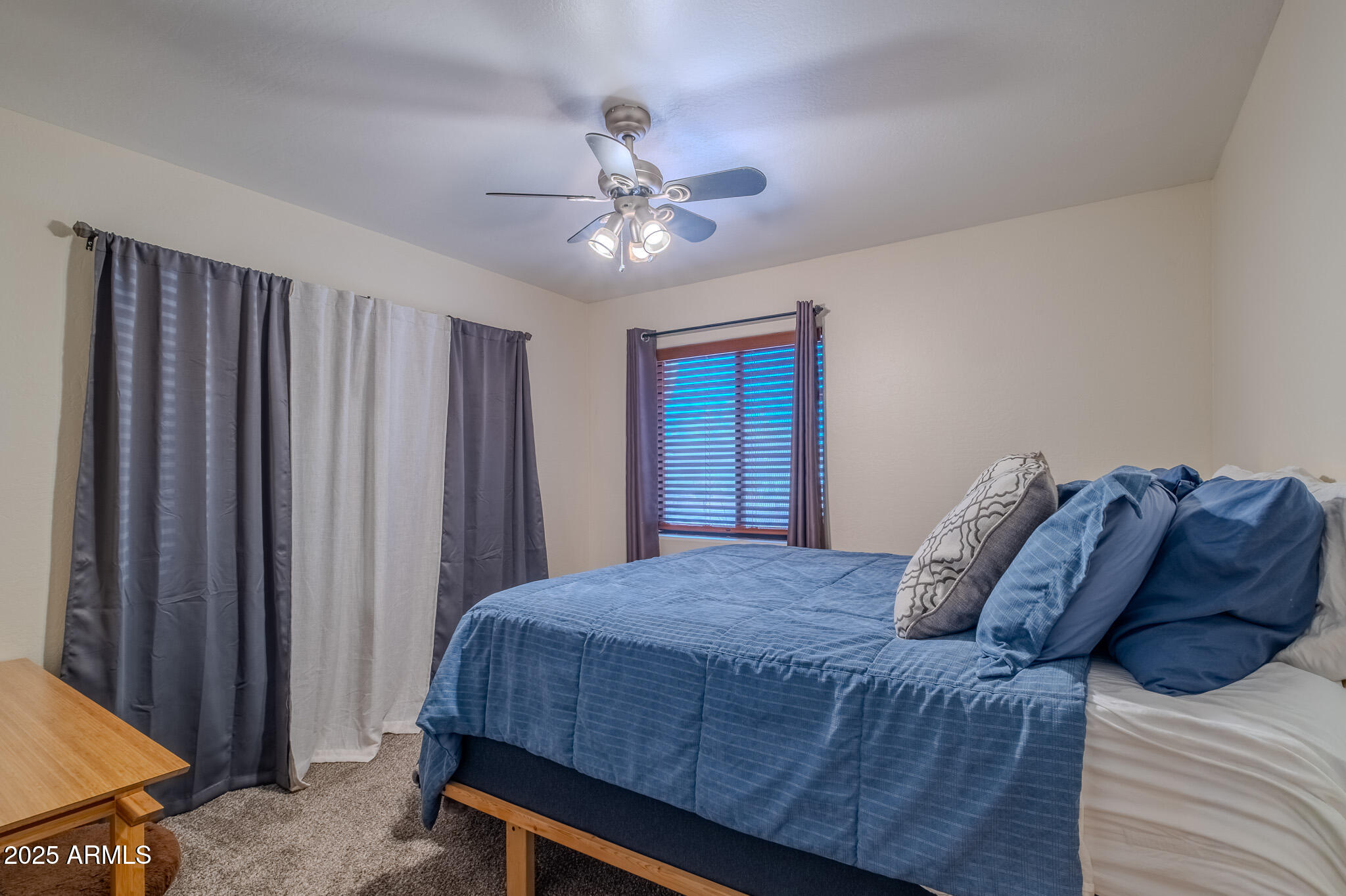 841 East Granada Avenue Apache Junction, AZ 85119 - Photo 22 of 33 a bedroom with a large bed and a chandelier