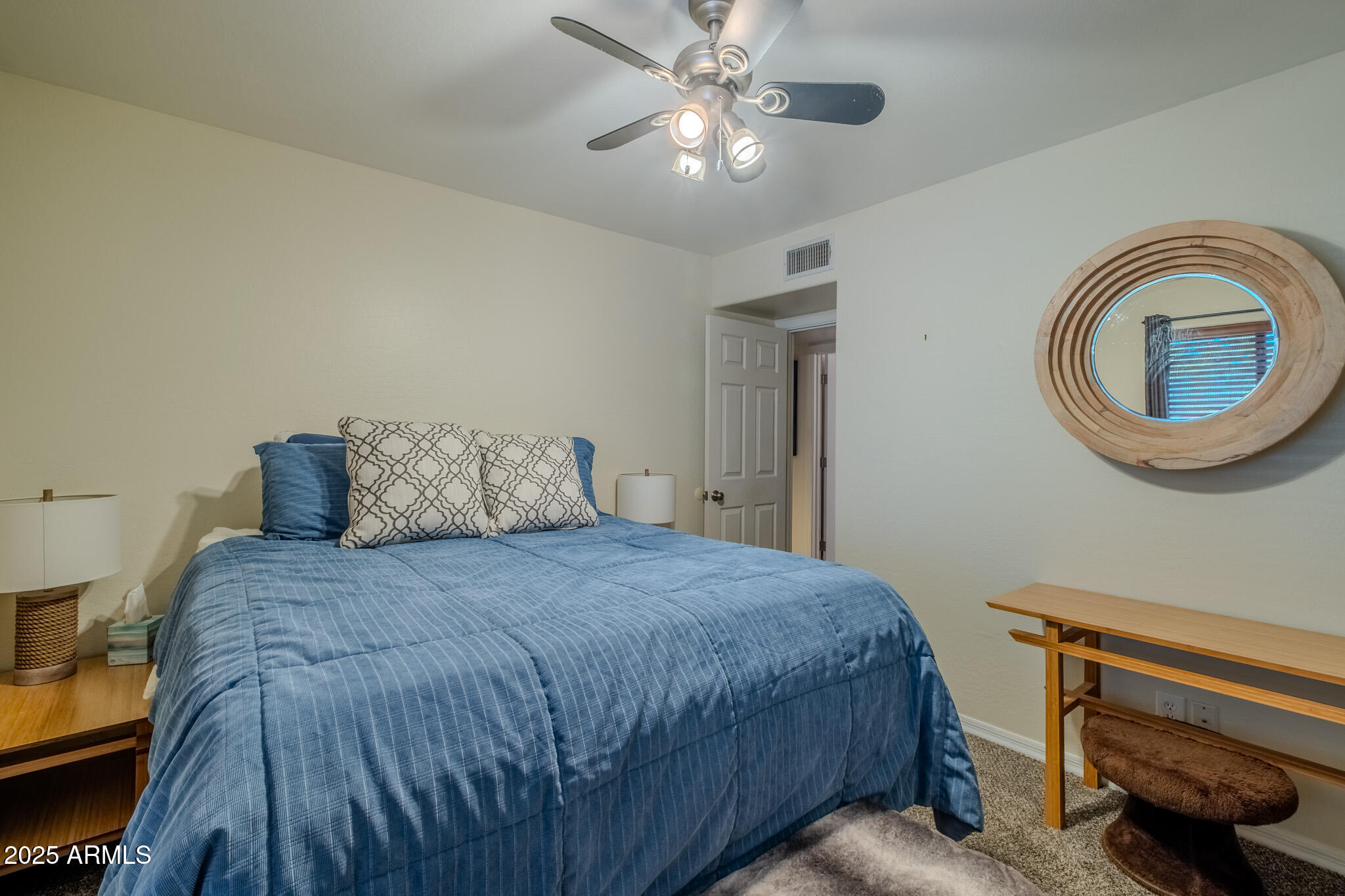 841 East Granada Avenue Apache Junction, AZ 85119 - Photo 23 of 33 a bedroom with a bed and a chandelier