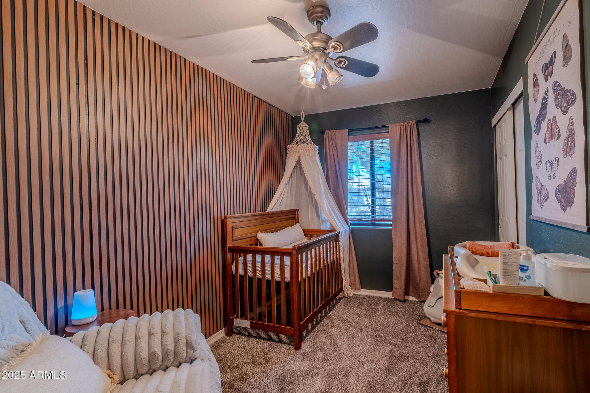 841 East Granada Avenue Apache Junction, AZ 85119 - Photo 24 of 33 a bedroom with a bed and a chandelier