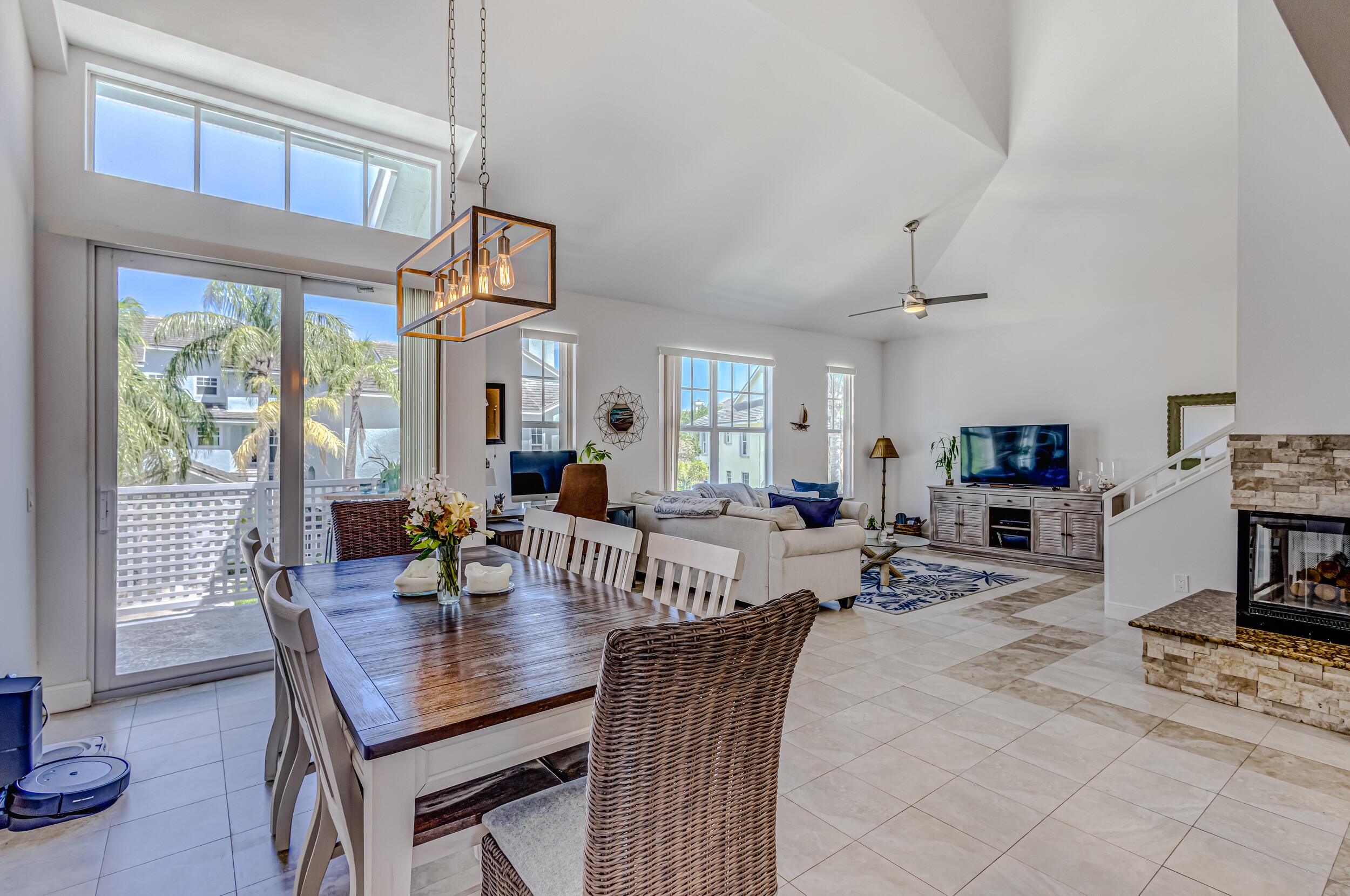 1701 Mizzenmast Way Jupiter, FL 33477 - Photo 23 of 64 a view of a dining room with furniture and a flat screen tv