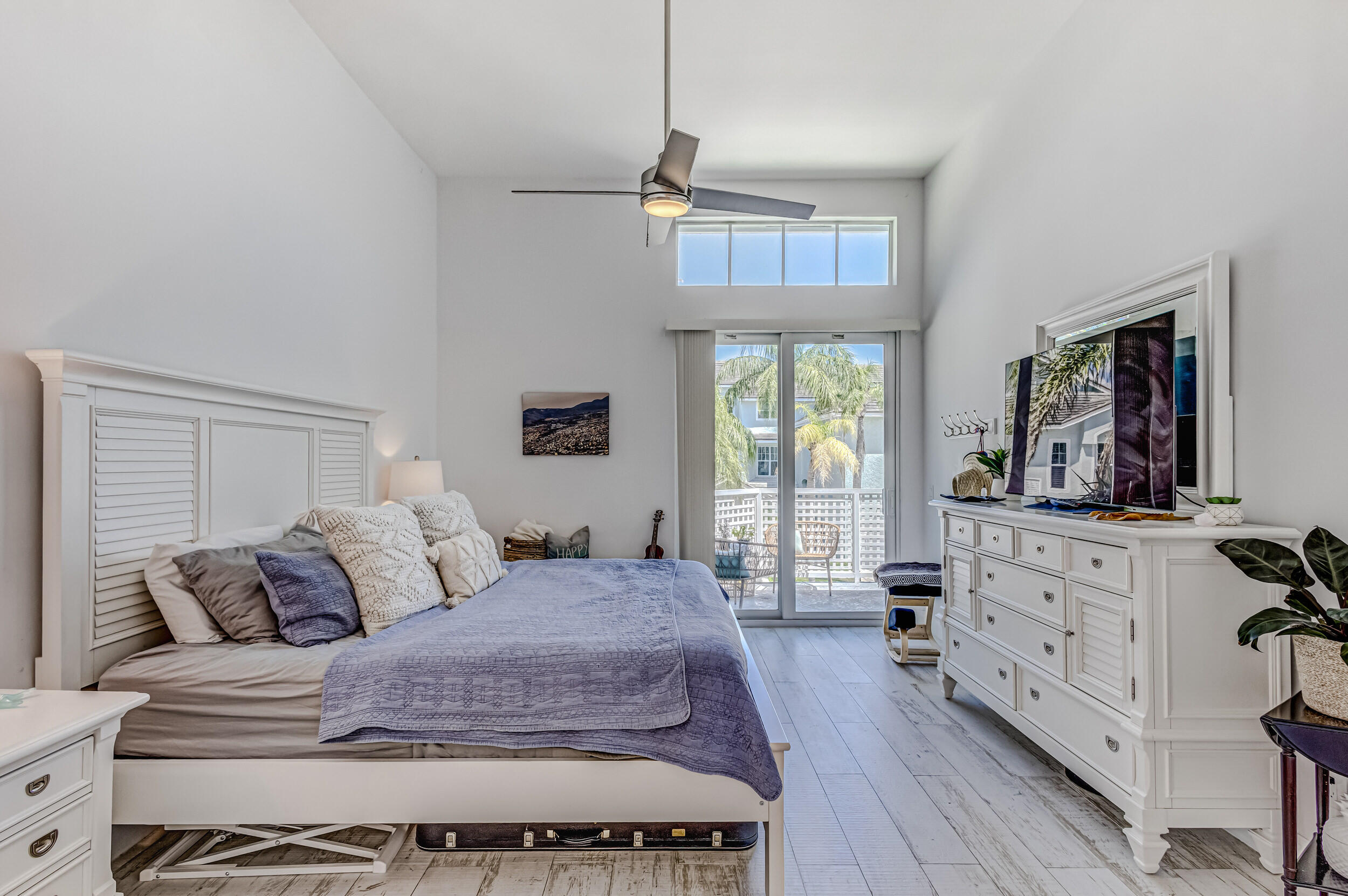 1701 Mizzenmast Way Jupiter, FL 33477 - Photo 26 of 64 a bedroom with a large bed and a flat tv screen on dresser