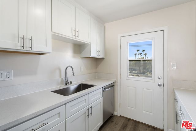 a kitchen with white cabinets and a sink