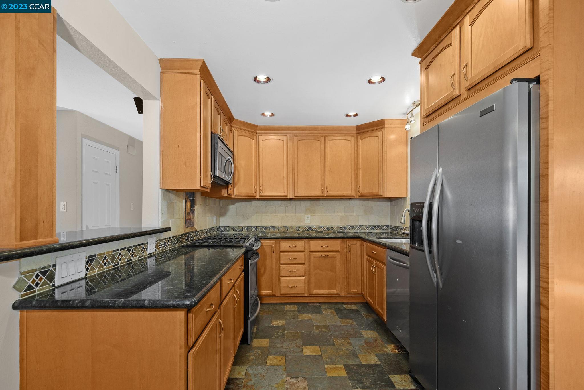 4266 Carter Court Concord, CA 94521 - Photo 12 of 26 a kitchen with stainless steel appliances granite countertop a sink stove and refrigerator