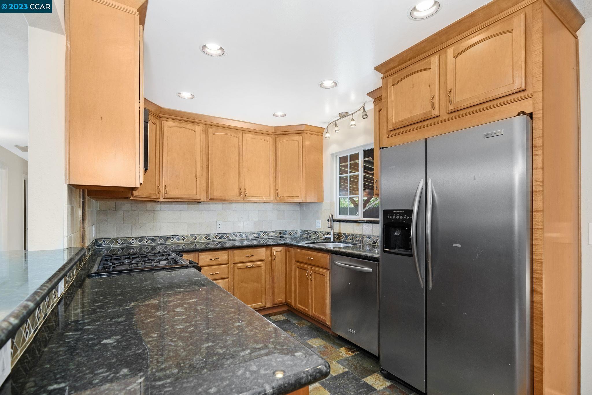 4266 Carter Court Concord, CA 94521 - Photo 13 of 26 a kitchen with stainless steel appliances granite countertop a refrigerator a sink a stove and oven
