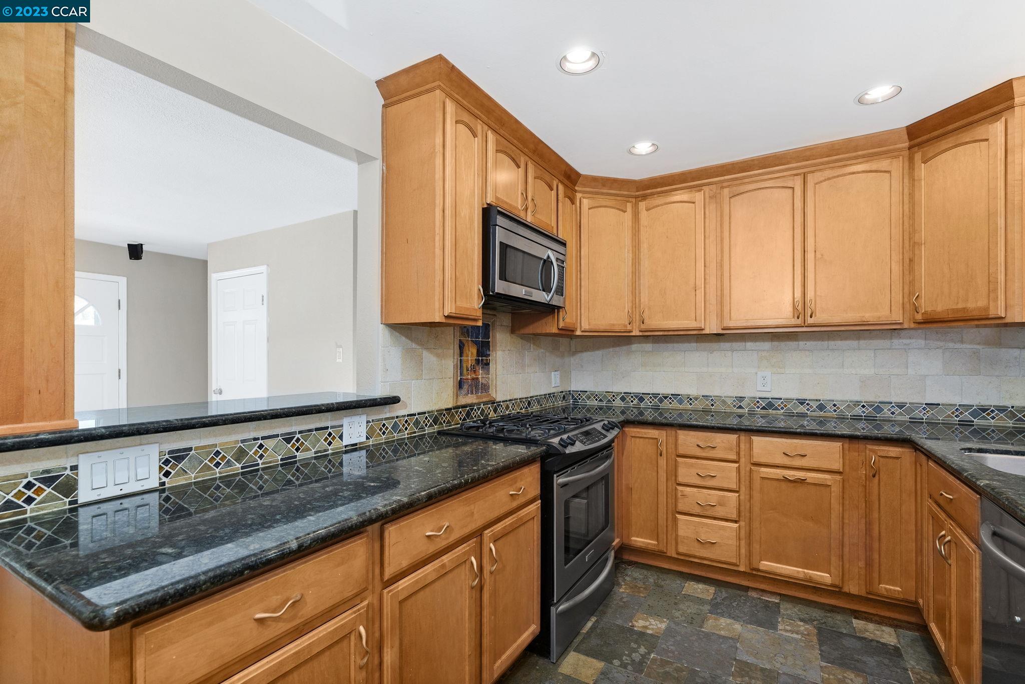 4266 Carter Court Concord, CA 94521 - Photo 14 of 26 a kitchen with stainless steel appliances granite countertop a sink stove and microwave