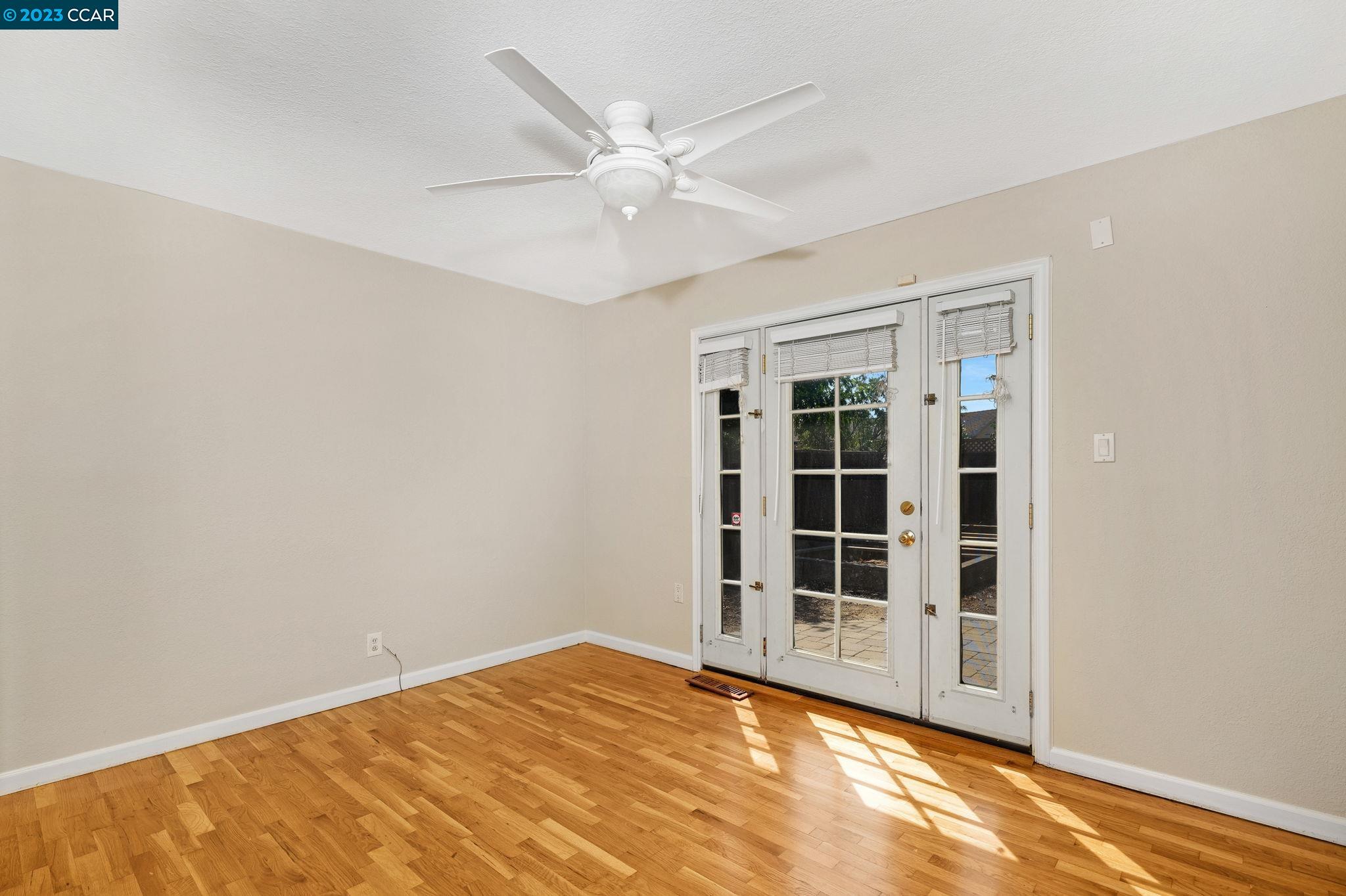 4266 Carter Court Concord, CA 94521 - Photo 15 of 26 a view of empty room with wooden floor and fan