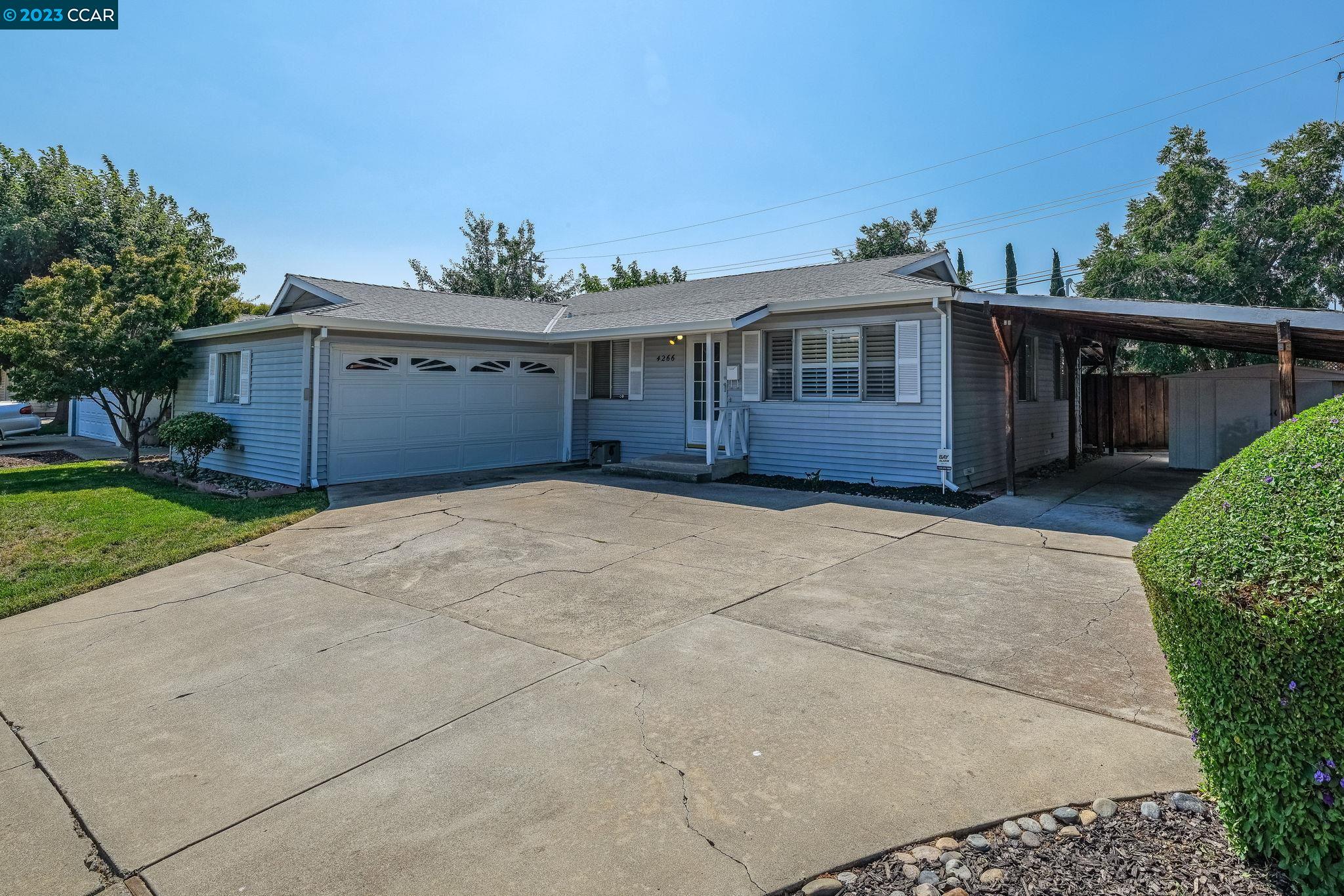 4266 Carter Court Concord, CA 94521 - Photo 2 of 26 a front view of a house with a garden