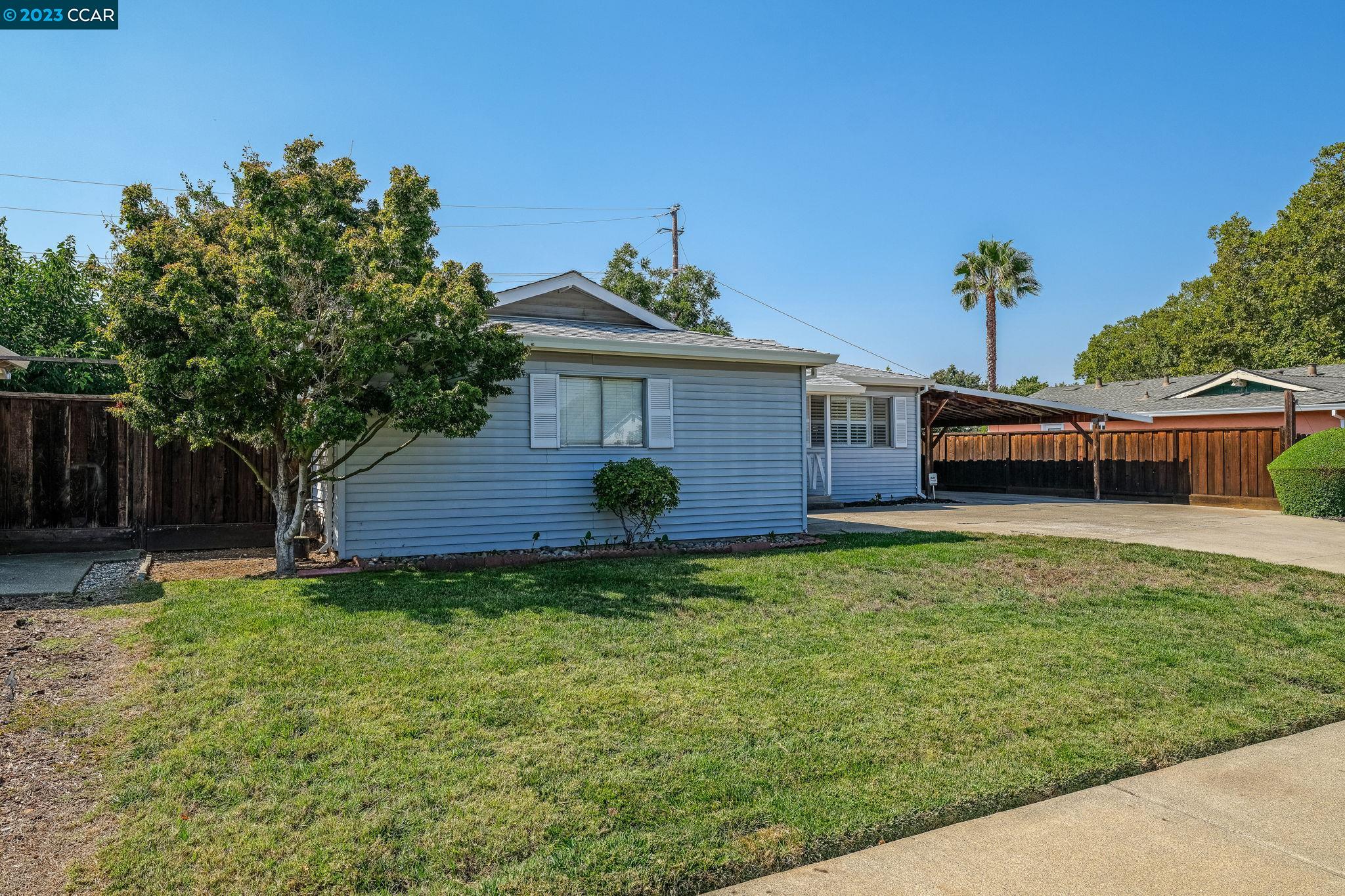 4266 Carter Court Concord, CA 94521 - Photo 3 of 26 a front view of a house with a garden