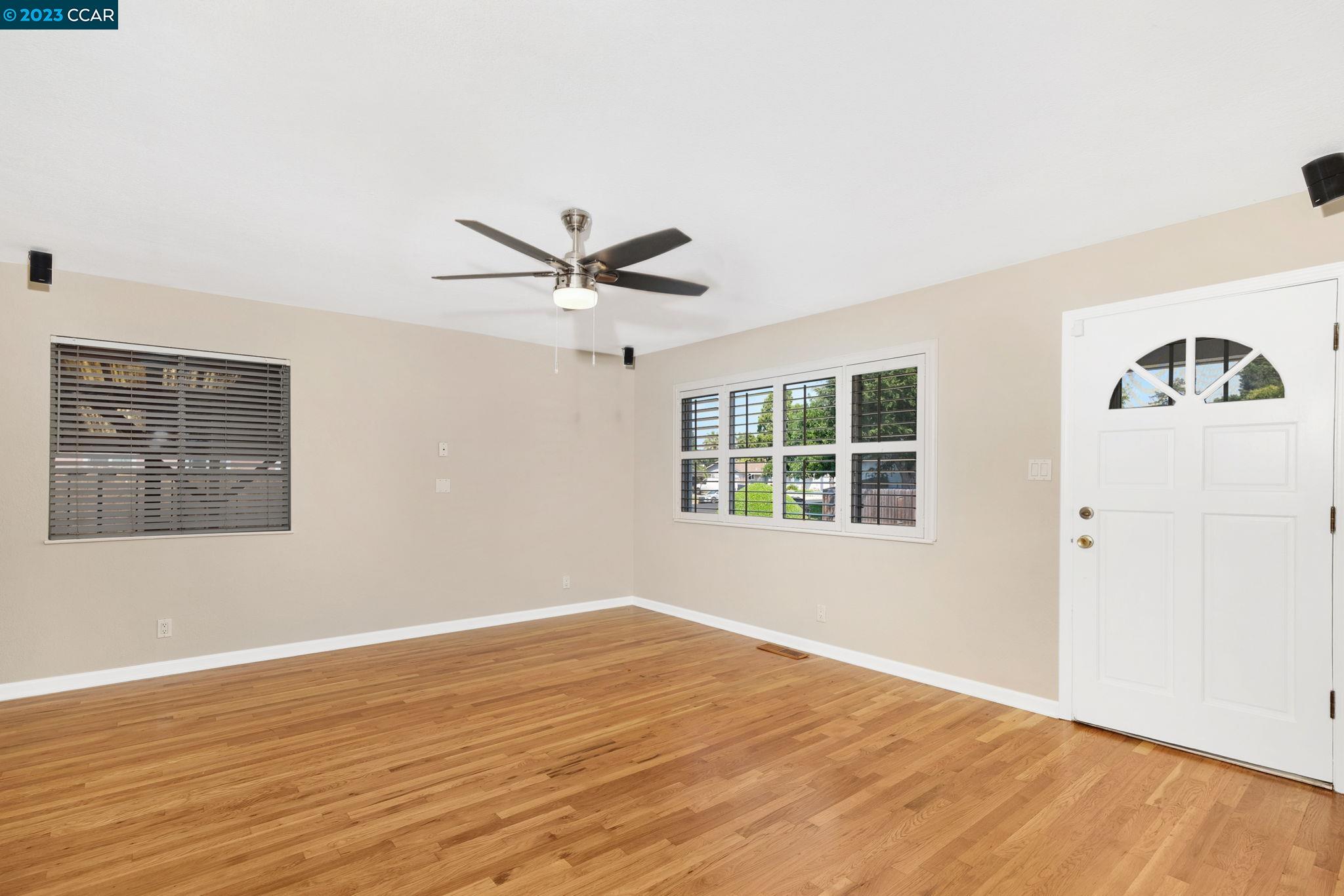 4266 Carter Court Concord, CA 94521 - Photo 6 of 26 a view of a big room with wooden floor and windows