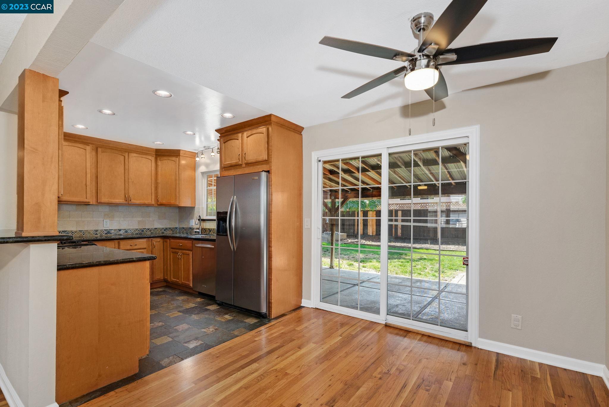 4266 Carter Court Concord, CA 94521 - Photo 10 of 26 a kitchen with granite countertop a refrigerator a sink and dishwasher a oven with wooden floor