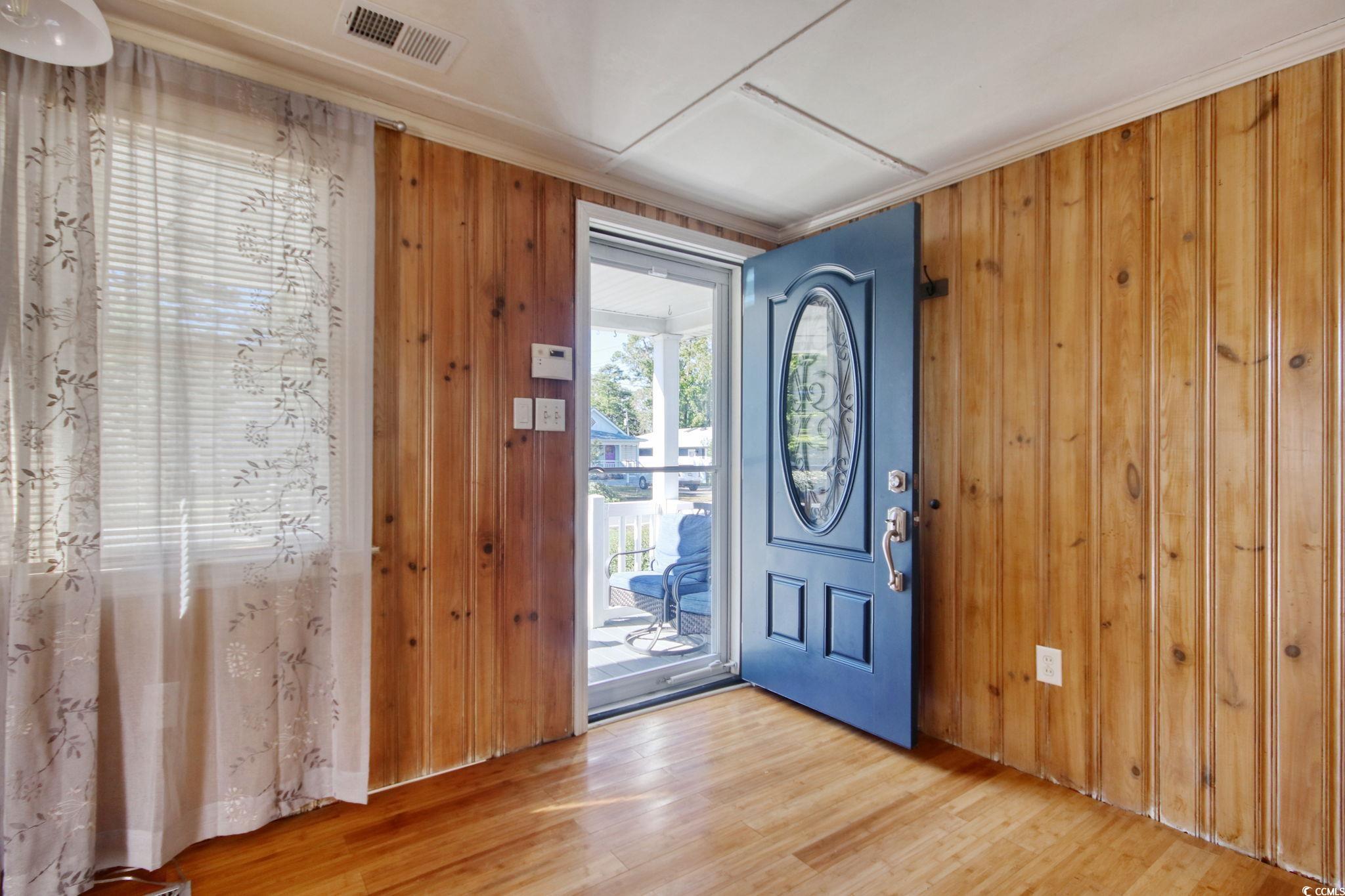 714 3rd Avenue South Surfside Beach, SC 29575 - Photo 3 of 30 Entryway with wooden walls and wood finished floors