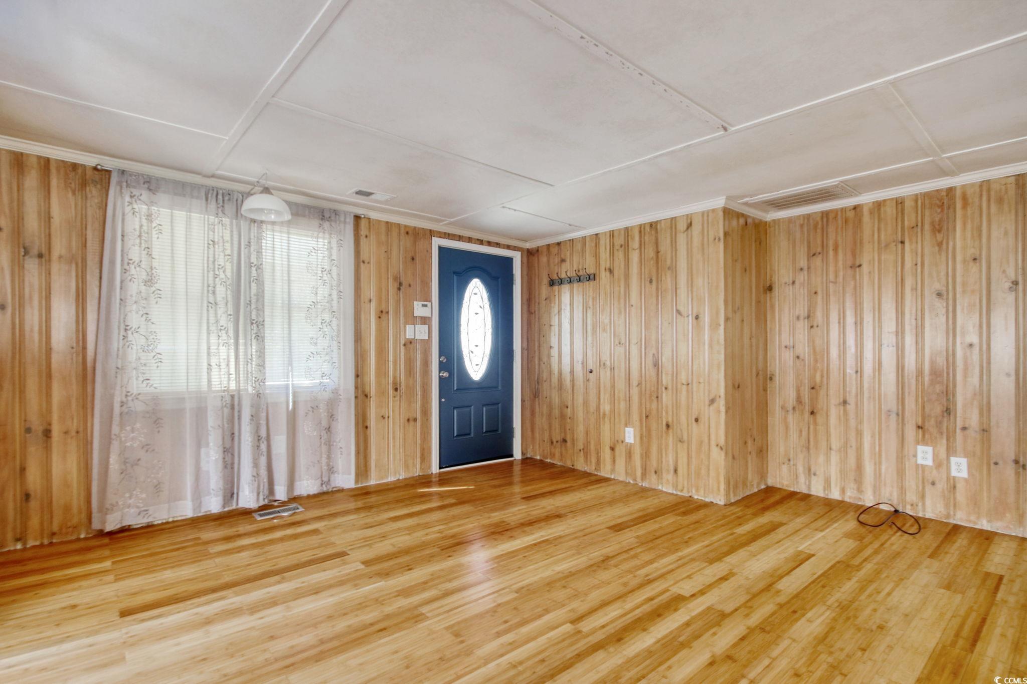 714 3rd Avenue South Surfside Beach, SC 29575 - Photo 5 of 30 Foyer entrance featuring wood walls and wood finished floors