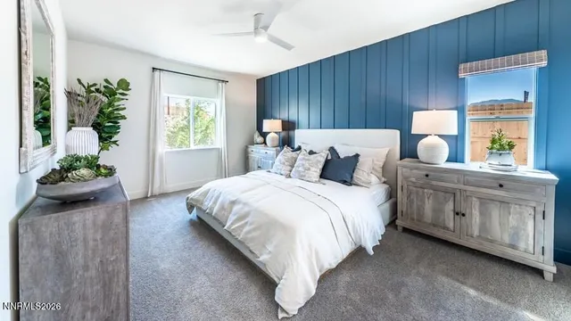 a bedroom with a bed table closet and a window