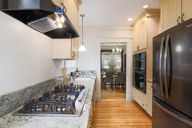 a kitchen with granite countertop a sink stainless steel appliances and cabinets