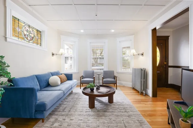a living room with furniture and wooden floor