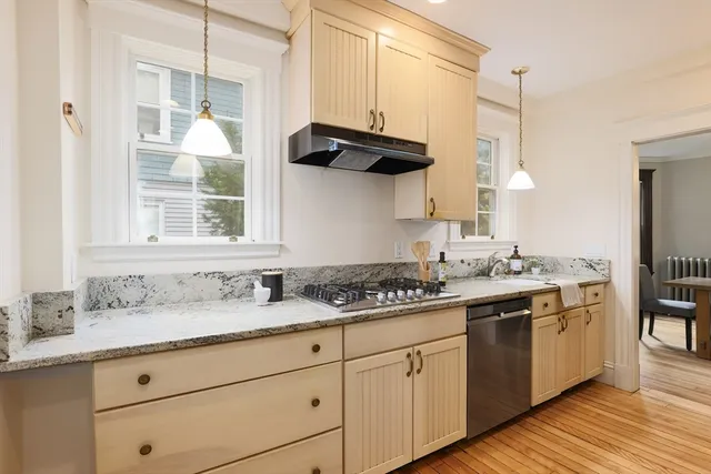 a kitchen with stainless steel appliances kitchen island granite countertop a refrigerator and stove