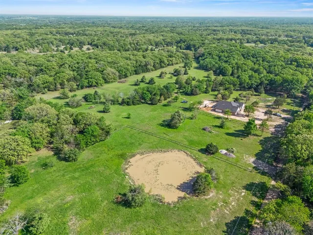 a view of a garden with a building in the background