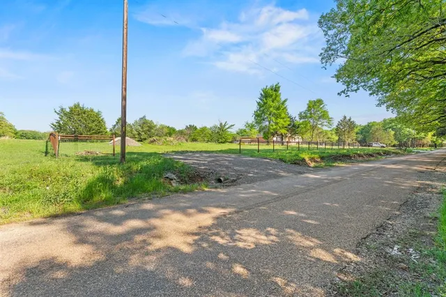 a view of a yard with iron fence