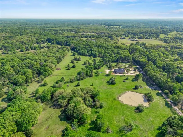 a view of a green field with lots of bushes