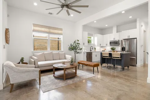 a living room with furniture and kitchen view
