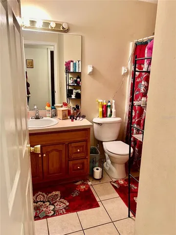 a bathroom with a sink toilet and mirror