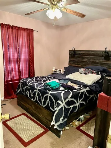 a bed sitting in a bedroom next to a window