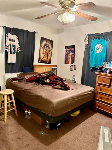 a bedroom with a bed and ceiling fan