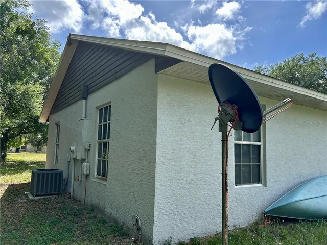 a view of backyard with cabin and wooden fence