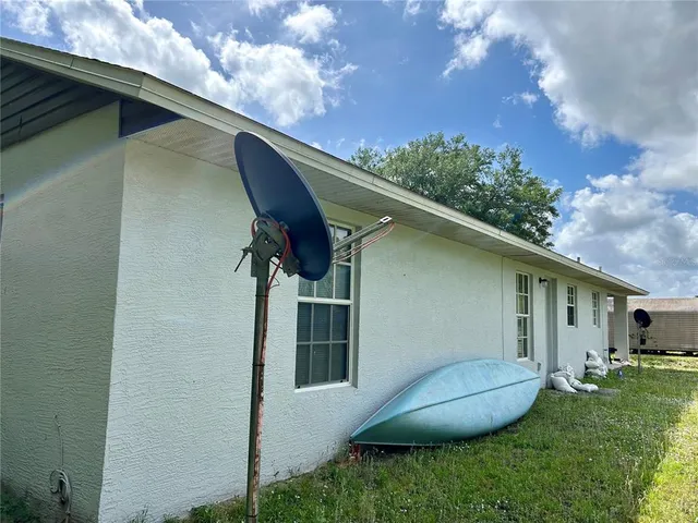 a view of a backyard with plants and a barbeque