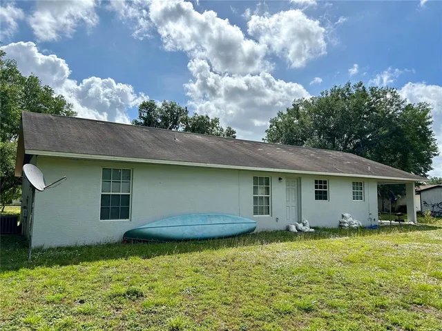 a house with huge green field in front of it