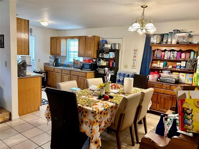 a dining room with furniture and a chandelier