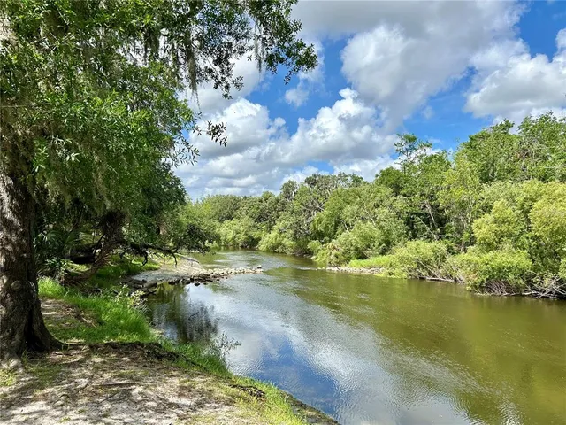 a view of a lake with houses in the background