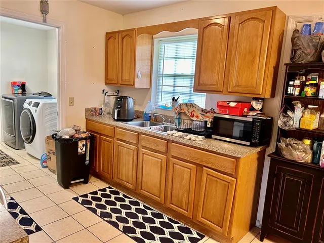 a kitchen with a sink a stove and cabinets