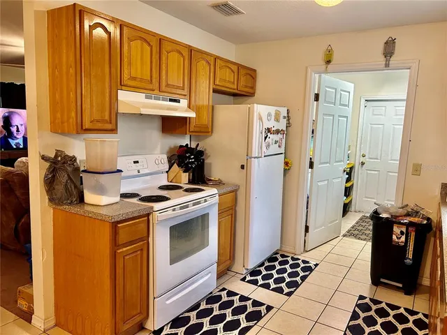 a kitchen with stainless steel appliances granite countertop a stove and a refrigerator