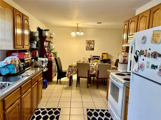 a group of people sitting in a kitchen and dining room