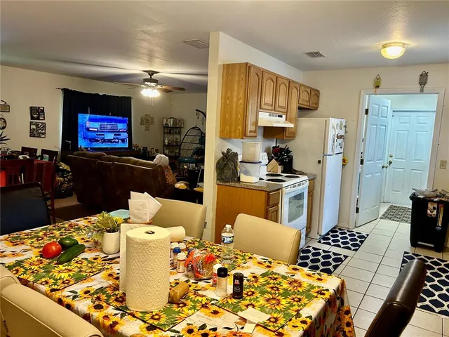 a living room with dining table and appliances