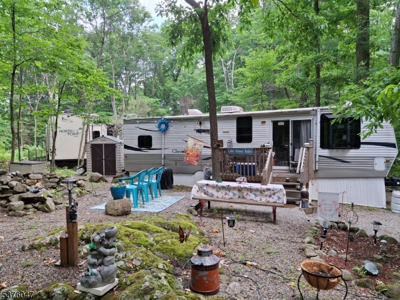 1 Pine Park Andover, NJ 07821 - Photo 2 of 2 a view of a backyard with furniture and a fire pit