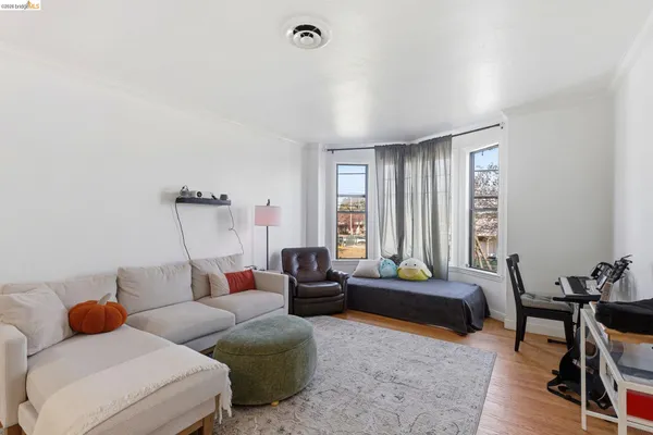 a living room with furniture window and wooden floor