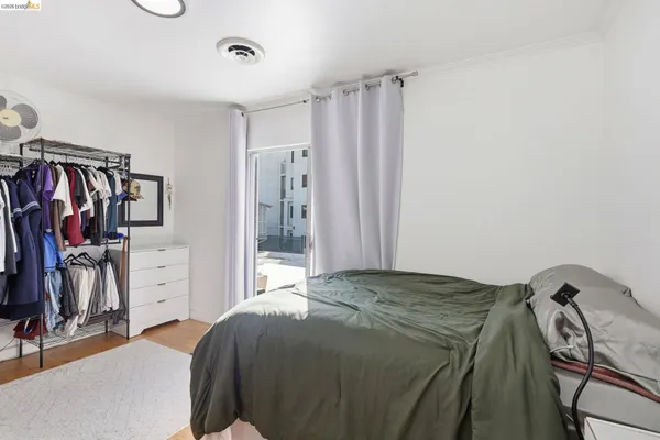 a bedroom with a bed and a dresser in it