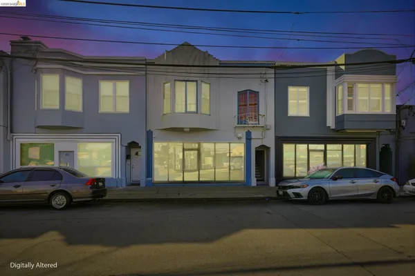 a couple of cars parked in front of a house