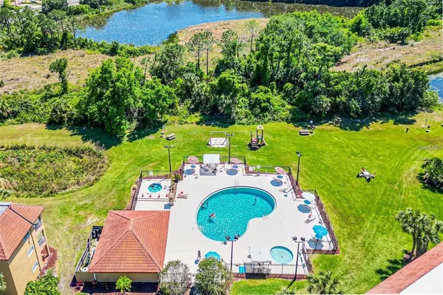 an aerial view of a house with outdoor space pool patio swimming pool and outdoor seating