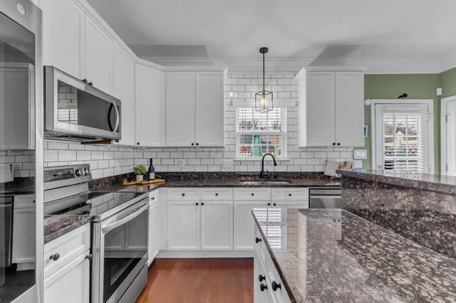 a kitchen with sink refrigerator and window