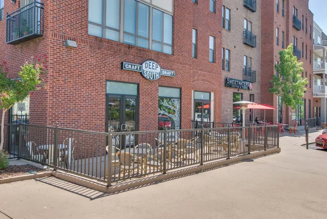 a front view of a residential apartment building with a yard