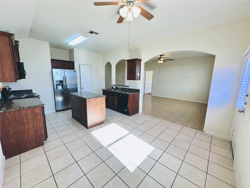 19309 W.T. Gallaway Street Manor, TX 78653 - Photo 20 of 38 a kitchen with stainless steel appliances a refrigerator and a stove top oven