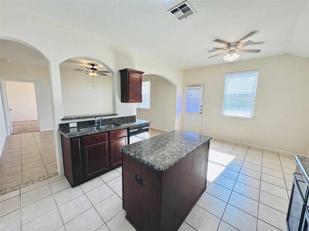 19309 W.T. Gallaway Street Manor, TX 78653 - Photo 24 of 38 a kitchen with stainless steel appliances granite countertop a stove a sink and a refrigerator