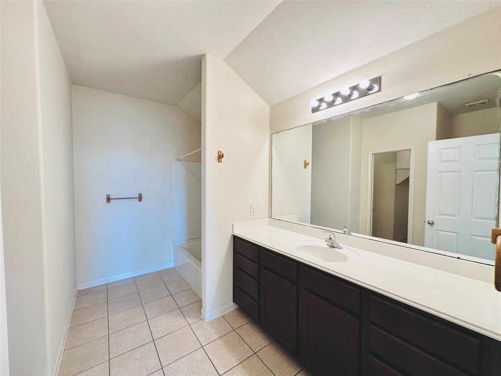 19309 W.T. Gallaway Street Manor, TX 78653 - Photo 29 of 38 a bathroom with a double vanity sink a mirror and a