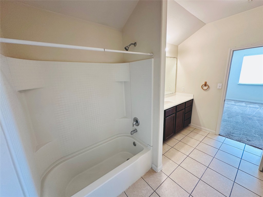 19309 W.T. Gallaway Street Manor, TX 78653 - Photo 30 of 38 a bathroom with a bathtub